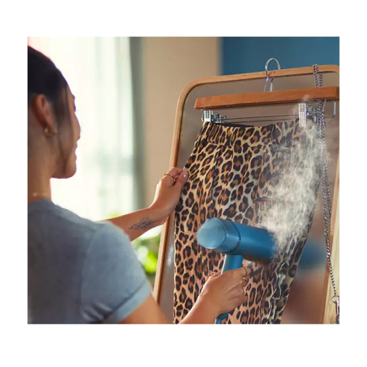 Philips 3000 Series STH3000/20 Garment Steamer in Blue, steaming a hanging shirt