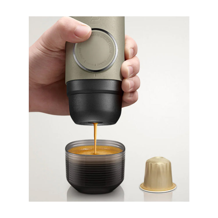 Wacaco Minipresso NS2 Portable Espresso Maker, pumping an espresso