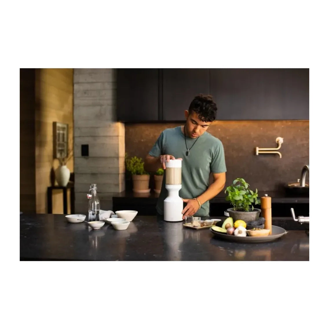 Beast Mighty B85MH Personal Blender in Cloud White, man preparing ingredients at a kitchen counter with the blender