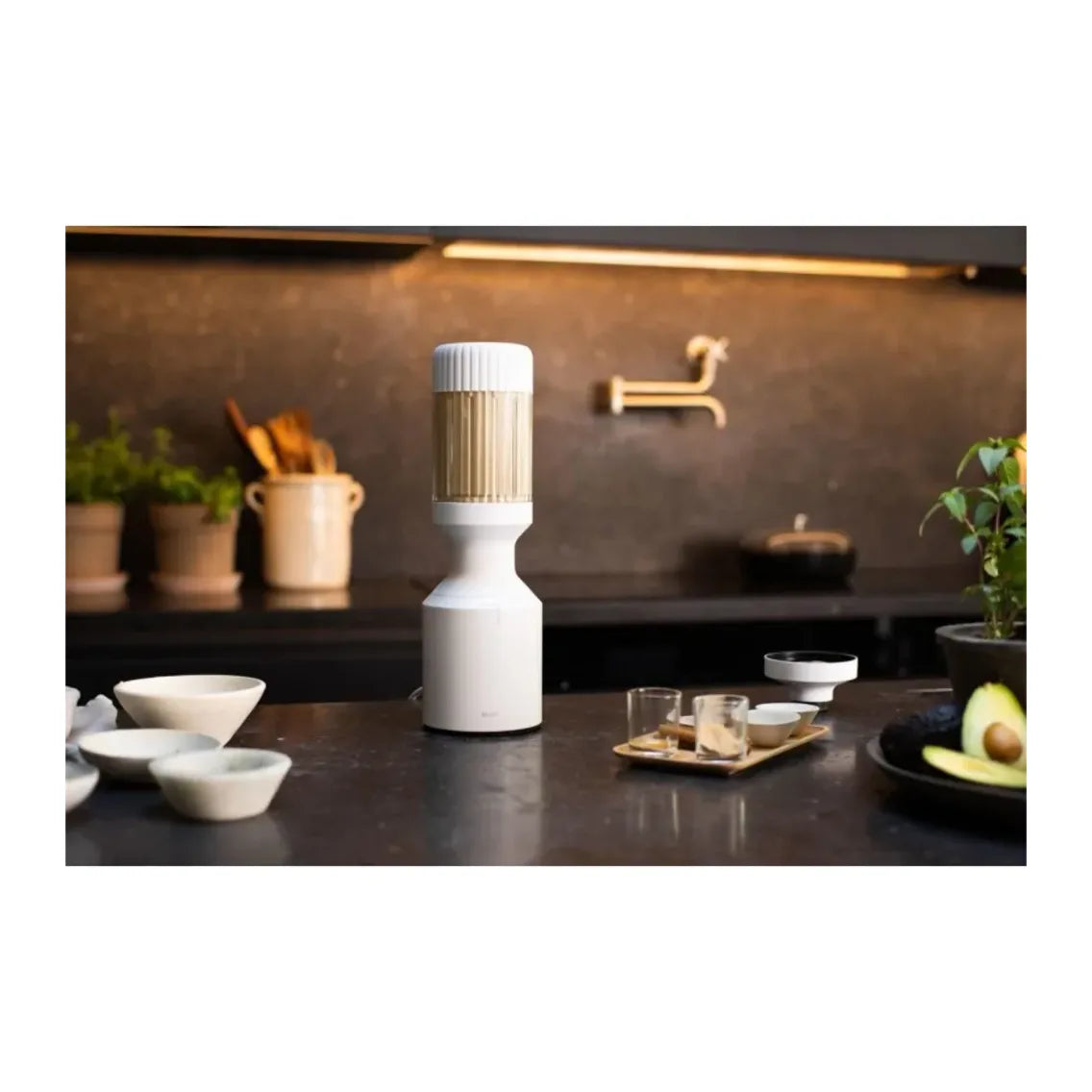 Beast Mighty B85MH Personal Blender in Cloud White, blender on a dark kitchen counter among bowls and glasses