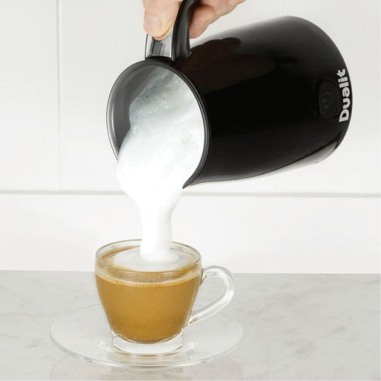 Dualit 84135 Milk Frother in Black, pouring frothed milk into a coffee