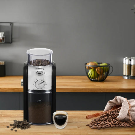 Krups Expert GVX242 Coffee Grinder in Black, on a counter with coffee beans