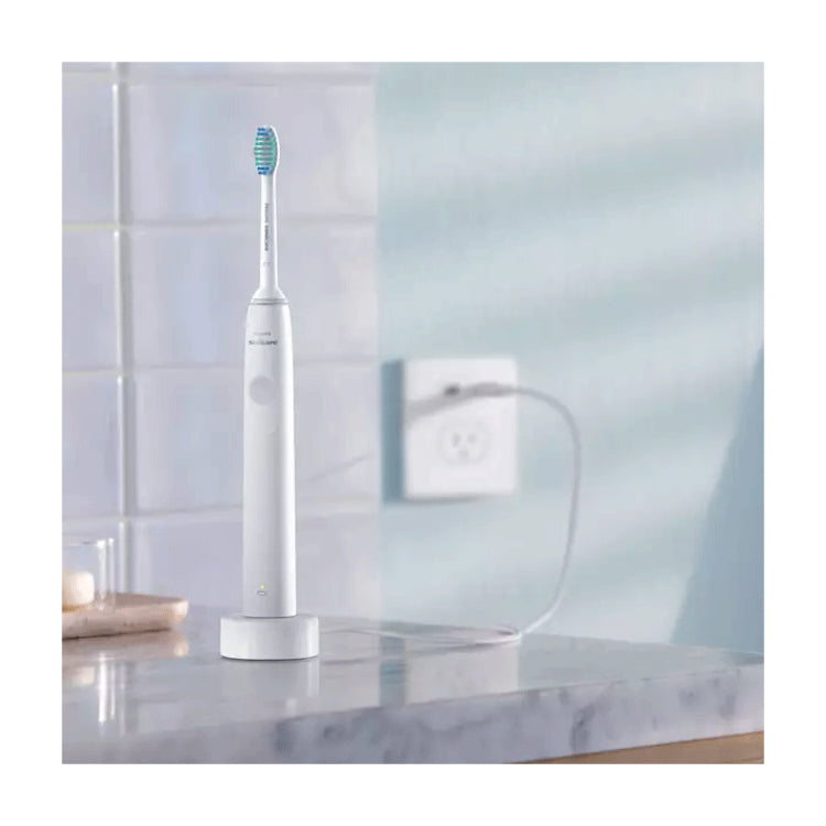 Philips Sonicare 1100 Series HX3641/02 Electric Toothbrush, on its charger in a bathroom