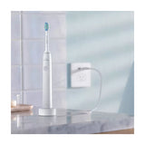 Philips Sonicare 1100 Series HX3641/02 Electric Toothbrush, on its charger in a bathroom