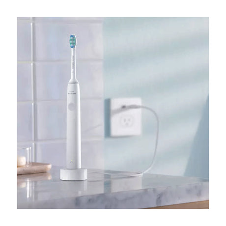 Philips Sonicare 1100 Series HX3641/02 Electric Toothbrush, on its charger in a bathroom
