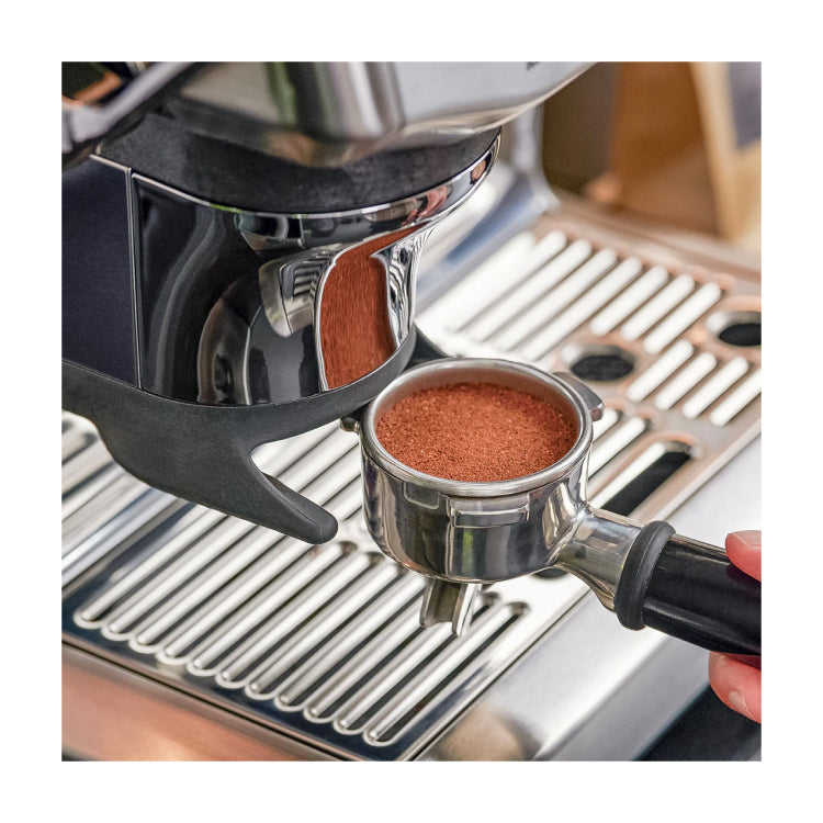 Sage Barista Express Impress SES876BSS Espresso Machine in Brushed Stainless Steel, close-up of the tamped portafilter