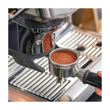 Sage Barista Express Impress SES876BSS Espresso Machine in Brushed Stainless Steel, close-up of the tamped portafilter