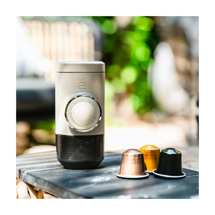 Wacaco Minipresso NS2 Portable Espresso Maker, outdoors with an espresso