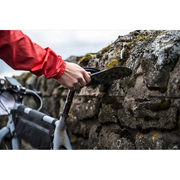 Ass Savers Big black clip-on mudguard for wide bicycle tires, mounted on saddle rails.