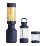 Beast Mighty B85MH Personal Blender in Navy, base with fruit-filled vessel next to carry vessel and small jar