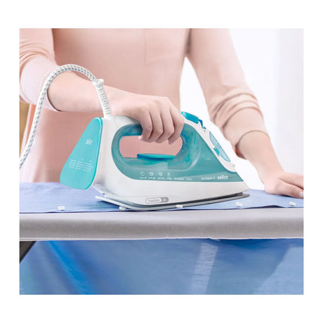 Braun TexStyle 3 SI3041GR Steam Iron in Turquoise, in use