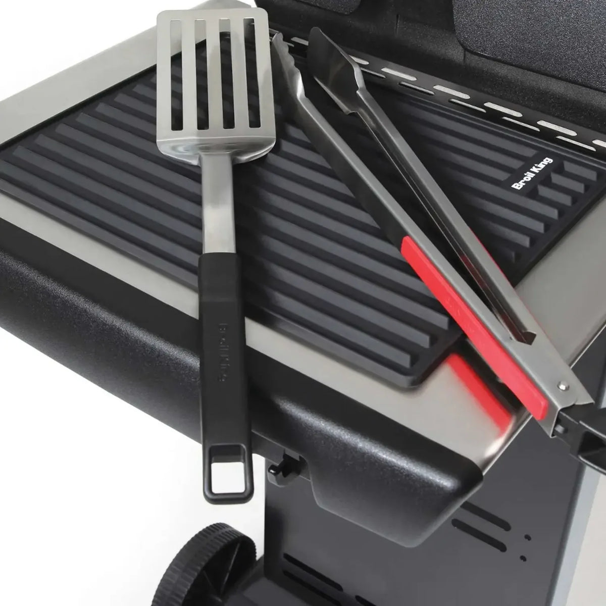Broil King 60009 in Black, in use on a grill side shelf with utensils