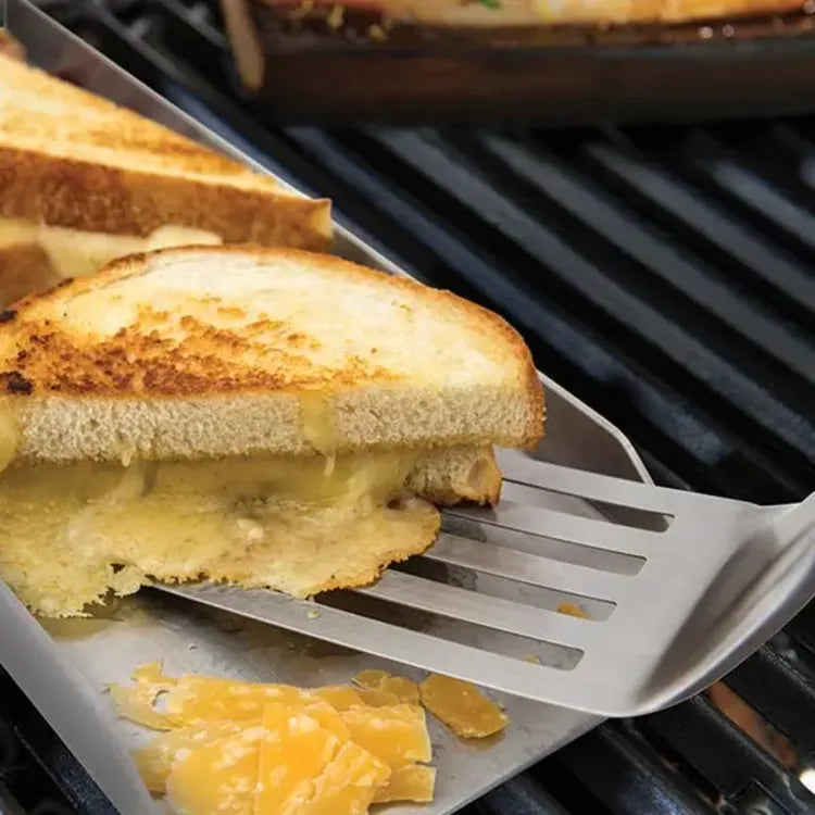 Broil King 64003, in use, lifting a grilled cheese sandwich on a grill