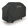 Broil King Select 67470 Grill Cover in Black, cover fitted over a grill on wheels