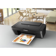 Canon PIXMA MG2551S All-In-One inkjet printer in black, showing the top scanner bed and compact design.
