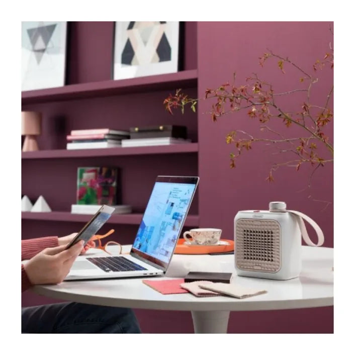 De'Longhi Capsule Desk HFX10B03.PK Fan Heater in Pink, in a room setting