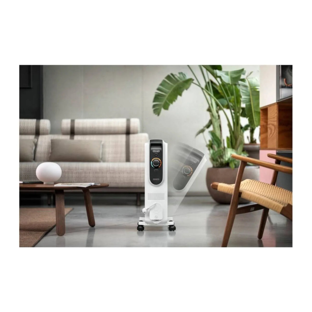 De'Longhi TRD51025DL, standing on a living room floor beside a sofa