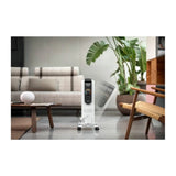 De'Longhi TRD51025DL, standing on a living room floor beside a sofa