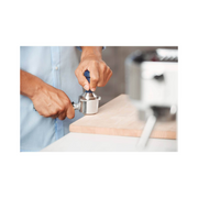 De'Longhi DLSC058 coffee tamper featuring a polished 51mm stainless steel base and an ergonomic grey wooden handle.