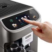 De'Longhi Magnifica Plus ECAM320.70.TB automatic coffee machine in titanium black featuring a 3.5-inch touch screen and milk carafe.