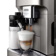 De'Longhi Magnifica Plus ECAM320.70.TB automatic coffee machine in titanium black featuring a 3.5-inch touch screen and milk carafe.