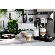 De'Longhi Magnifica Plus ECAM320.70.TB automatic coffee machine in titanium black featuring a 3.5-inch touch screen and milk carafe.
