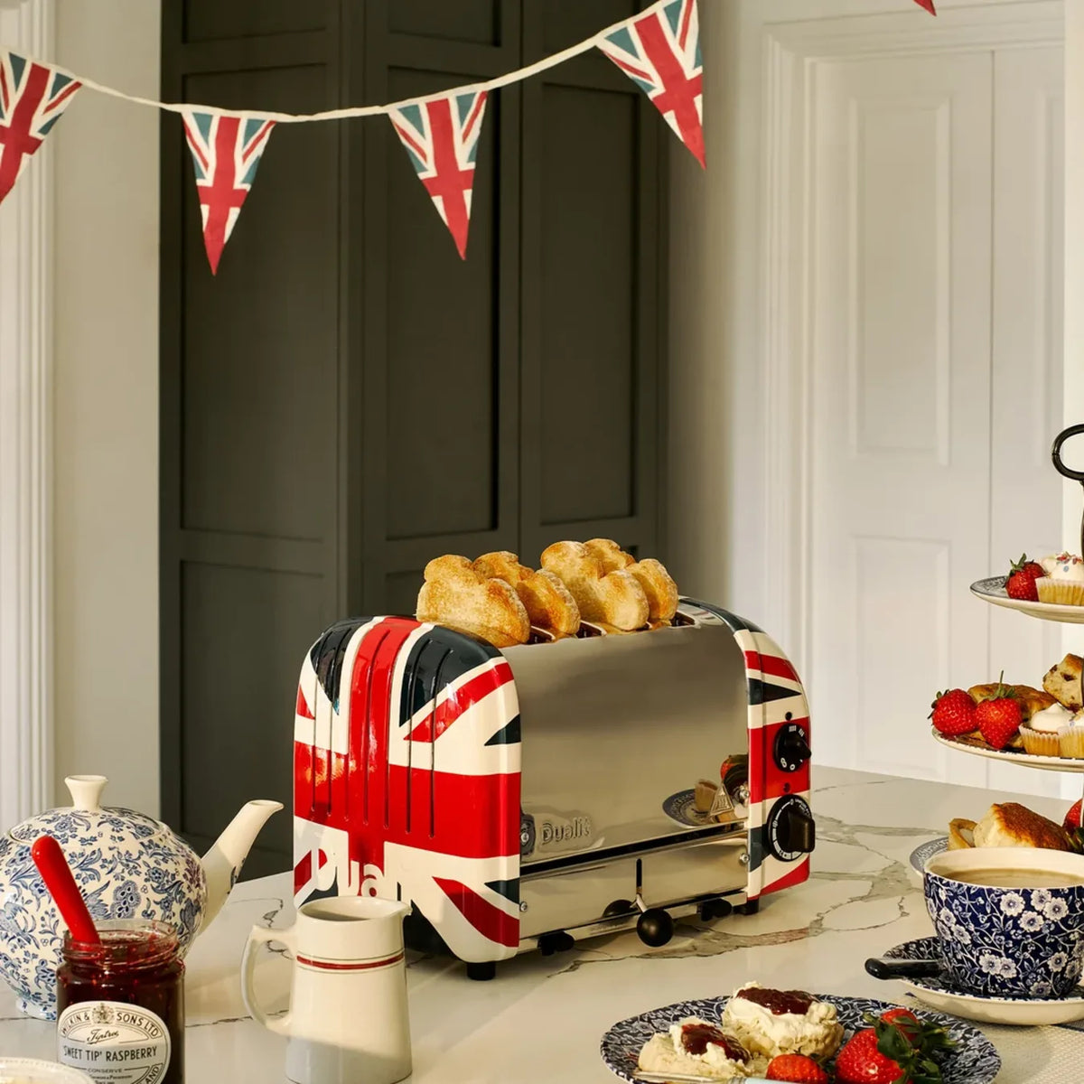 Dualit 47205, on a worktop with bunting, scones and tea cups
