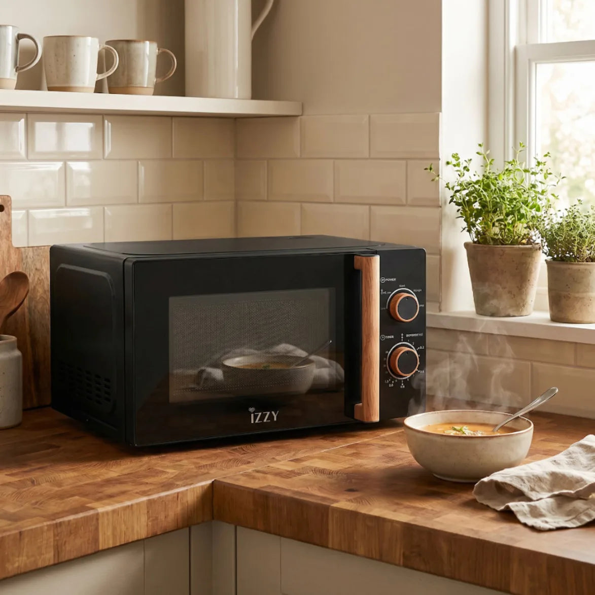 Izzy IZ-8006 Microwave Oven in Black, in a room setting