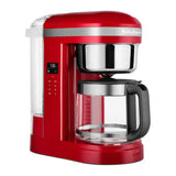 KitchenAid 5KCM1209BER in Empire Red, three-quarter view showing the display and clear water tank