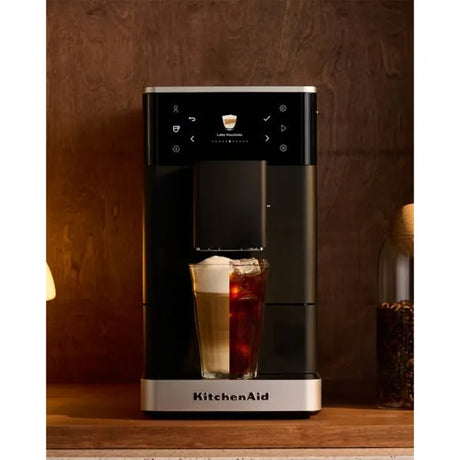 KitchenAid 5KES8453B in Matte Black, on a wooden shelf with a latte and iced coffee