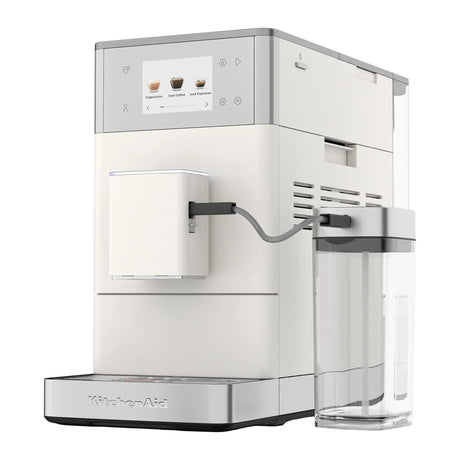 KitchenAid 5KES8454 in Porcelain White, three-quarter view of the light coloured machine with milk jug