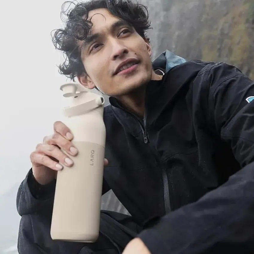 LARQ PuerVis 2 in Mojave Dune, person holding the bottle outdoors in a dark jacket