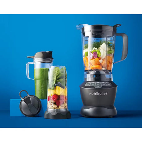 Nutribullet Combo NBF500DG Blender in Dark Grey, jug and to-go cups with ingredients on a blue background