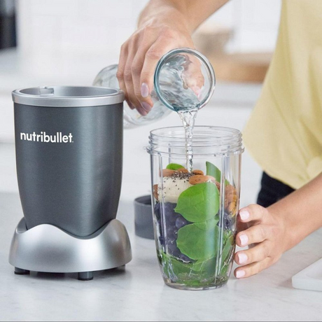 Nutribullet Original NB606DG Personal Blender in Silver Grey, pouring a smoothie