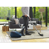 Rowenta RO3125 in Blue, man vacuuming a rug in a living room