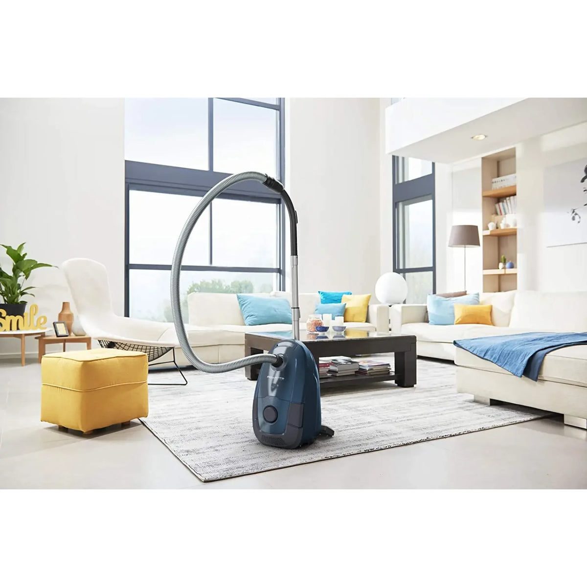 Rowenta RO3125 in Blue, standing on a rug in a bright living room