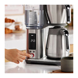 Sage SDC465BSS4GUK1, hand pressing the dial beside the lit display