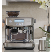 Sage Barista Pro SES878BST4GUK1 espresso machine in matte black truffle featuring an integrated grinder and digital LCD screen.