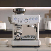 Sage the Barista Express Impress espresso machine in Sea Salt White with integrated tamper lever and bean hopper.