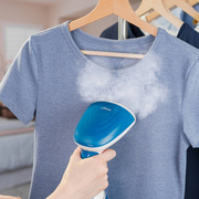 Ufesa GS1700 1700W handheld garment steamer in white and blue, featuring a stainless steel head and removable water tank.