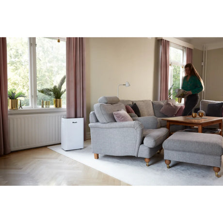 Wood's MRD20GW in White, in a lounge with a person reading nearby