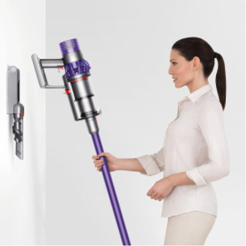Dyson Cyclone V10 Absolute Cordless Vacuum Cleaner in Copper/Nickel, taken from its wall dock