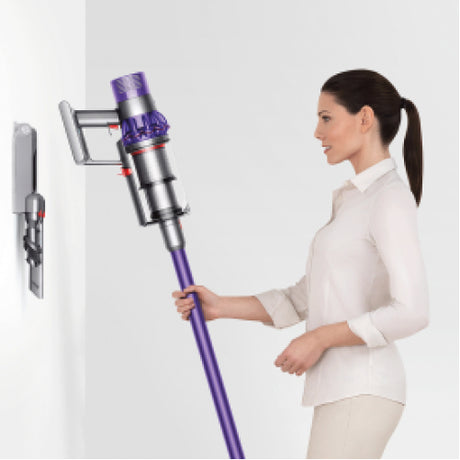 Dyson Cyclone V10 Absolute Cordless Vacuum Cleaner in Copper/Nickel, taken from its wall dock