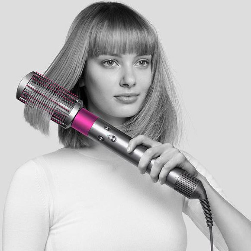 Dyson Airwrap Complete HS01 Multi-Styler in Nickel/Fuchsia, in use