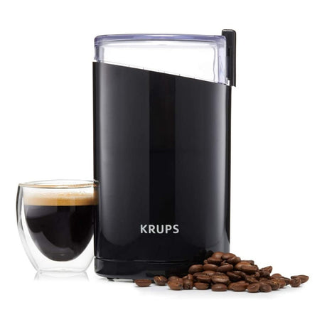 Krups F203 Coffee Grinder in Black, with ground coffee and a cup